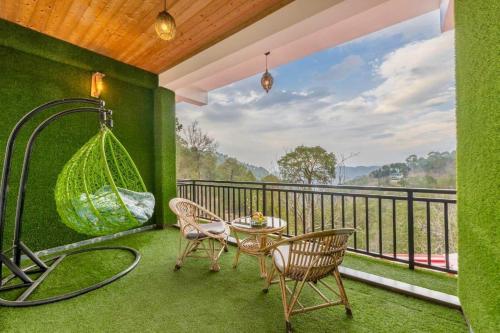 a balcony with a hammock and a table and chairs at Evening Sky Homestay - Kasauli !!! in Kasauli