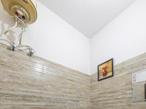 a bathroom with a stone wall with a light at Evening Sky Homestay - Kasauli !!! in Kasauli