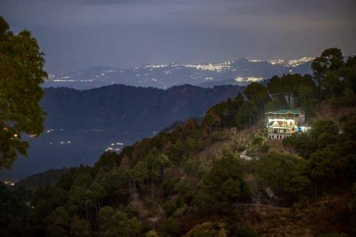 a house on top of a hill in the mountains at Evening Sky Homestay - Kasauli !!! in Kasauli