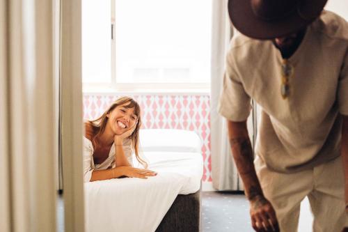a man standing next to a woman in a bed at Stay Hotel Faro Centro in Faro
