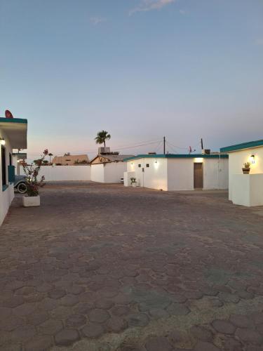 an empty parking lot with two buildings in the distance at #53 Bungalow Seaside Hotel & Victors RV Park in San Felipe