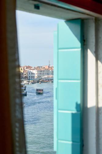 a view of a river with boats on it at Hotel Santa Chiara in Venice
