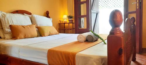 a bedroom with a large bed with a wooden headboard at Maison avec Jardin et salle de sport in Capesterre-Belle-Eau