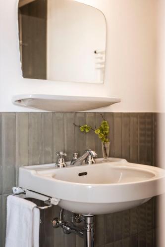 a white sink in a bathroom with a mirror at Ansitz Thierburg Suites in Merano
