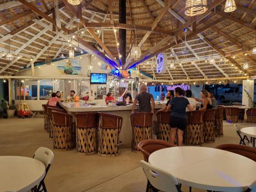 a group of people at a bar in a restaurant at #53 Bungalow Seaside Hotel & Victors RV Park in San Felipe