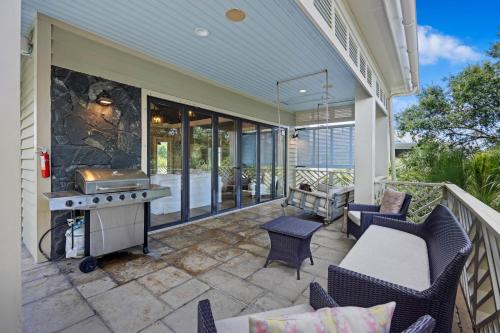 a patio with chairs and a grill on a house at AV9-02: 9 2nd Avenue in Isle of Palms