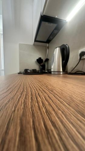 a kitchen with a wooden counter top with a coffee pot at Luna Home in Jermuk