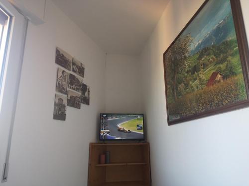 a room with a television and a painting on the wall at Il Rifugio di Mario in Monzuno