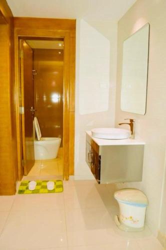 a bathroom with a sink and a toilet and a shower at Yara Suites in Buraydah