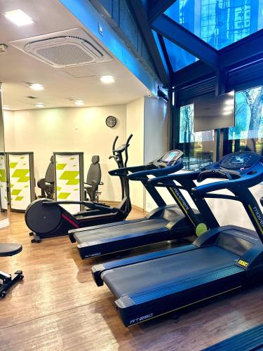 a gym with several tread machines in a room at Flat 805 - Avenida Ibirapuera, Moema - São Paulo in Sao Paulo