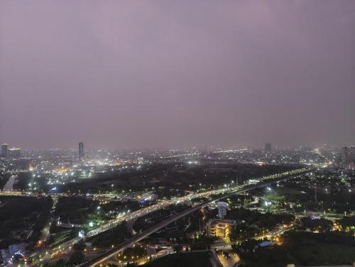 an aerial view of a city at night at Cloud stays 36th floor in Noida