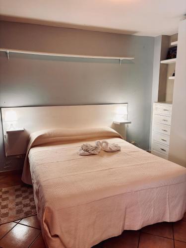 a bedroom with a bed with a towel on it at La casetta di Nonna Rosa in Santa Domenica