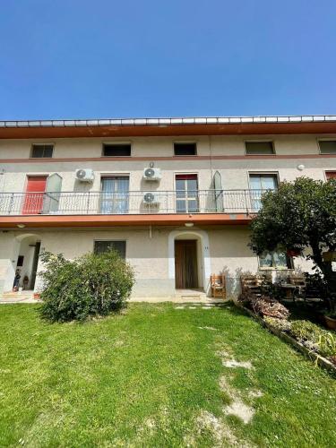 a building with a grass yard in front of it at La porta del Gran Sasso in Montorio al Vomano