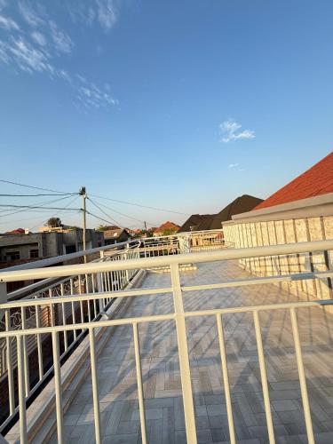 a balcony with white railings on top of a building at Hillside House in Kigali
