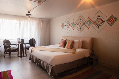 a bedroom with a bed and a table in a room at NAIA Miraflores Lima- Formerly Selina Miraflores Lima in Lima