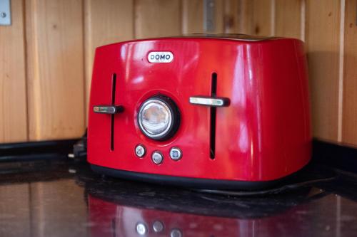 a red toaster sitting on top of a counter at Chalet, breathtaking sea view with large jacuzzi in Almuñécar