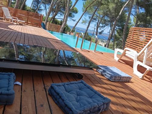 a deck with a view of a swimming pool at Villa vu mer et étang de thau in Sète