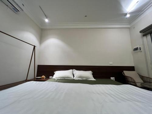 a bedroom with a large white bed in it at Lá house Hà Nội in Dong Anh