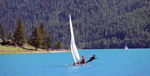 two people on a sail boat in the water at BALMA DEI CUP con SPA privata su richiesta in Pont Canavese