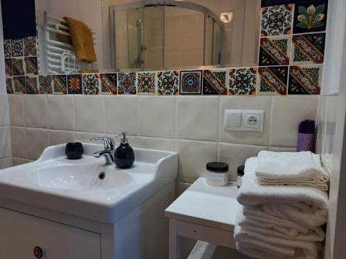 a bathroom with a sink and a mirror and towels at Winnica Brochów in Brochów