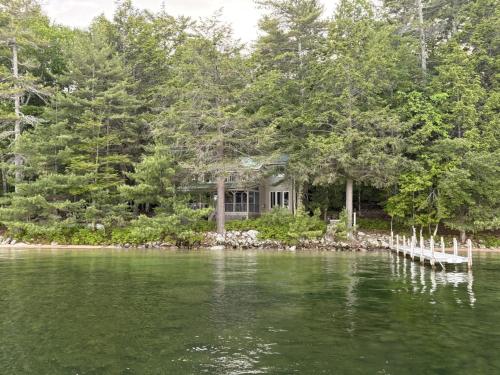 a house on the shore of a body of water at Sandy Beach, Private Dock & Boat Access in Meredith