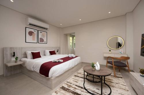 a bedroom with a large bed and a table at Book Today & save 88 Escape by Spacey Pool-Modern-Prime spot #73- in Cairo