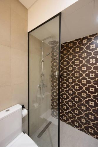a bathroom with a shower and a toilet at Book Today & save 88 Escape by Spacey Pool-Modern-Prime spot #73- in Cairo