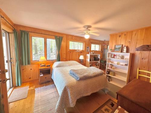 a bedroom with a bed and a desk at Sandy Beach, Private Dock & Boat Access in Meredith