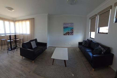 a living room with a couch and chairs and a table at Esperance Ocean Escape in Esperance