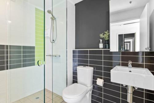 a bathroom with a toilet and a sink at Serrata - 2B2B Docklands Apt Parking Available in Melbourne