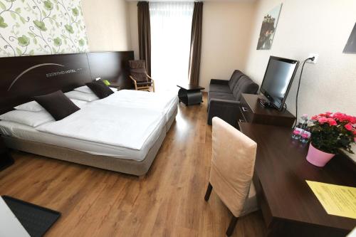 a living room with a bed and a couch at Ezüsthíd Hotel in Veszprém