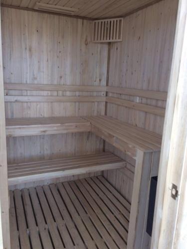 a wooden sauna with wooden benches in it at Dpto Vista al Mar, La Herradura in Coquimbo