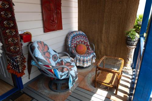 two chairs on the porch of a house at Chalet, breathtaking sea view with large jacuzzi in Almuñécar