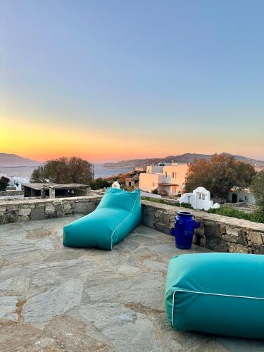 a group of blue inflatable slides on a stone wall at Villa Ruffi Mykonos in Mikonos
