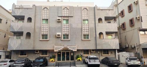 a large building with cars parked in front of it at شقة35 in Al-Safa