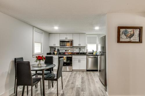 a kitchen with a table and chairs and appliances at 2 Mi to USC Campus Peaceful Apartment with Yard in West Columbia