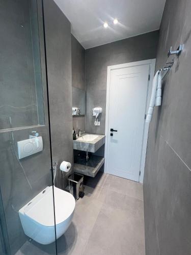 a bathroom with a toilet and a sink at Hotel Sisana in Vlorë
