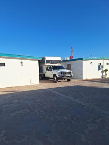 a truck parked in a parking lot next to a building at #36 Bungalow Seaside Hotel & Victors RV Park in San Felipe