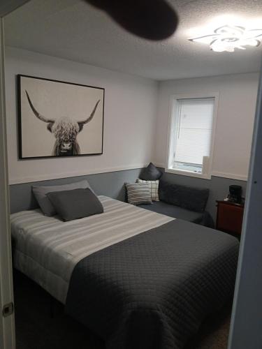 a bedroom with a bed with a bull skull on the wall at Aurora Nights in Fairbanks
