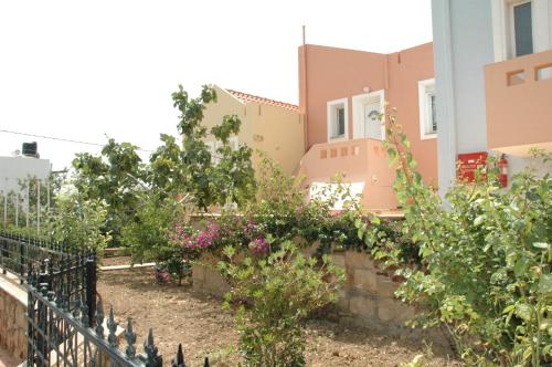 a garden in front of a house at Toulipa Rooms in Agia Ermioni