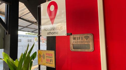 a red door with a sign on it and a wii password sign at At Home สระบุรี in Sara Buri