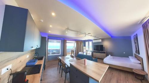 a room with a room with a bed and a desk at POSEIDON Seaview Presidential in Paralia Katerinis