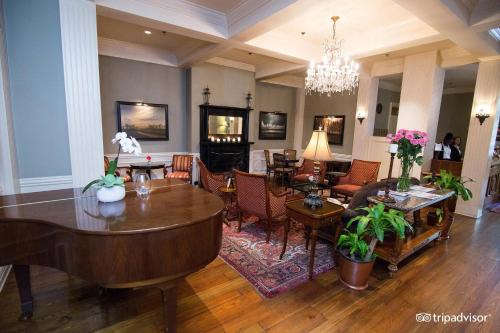 a living room with a table and chairs at River Inn of Harbor Town in Memphis