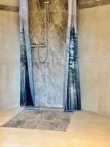 a shower in a bathroom with a shower curtain at Schlossblick Komfort Apartment in Weilburg