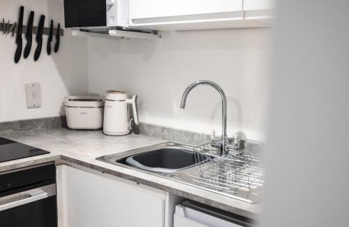 a kitchen with a sink and a counter top at Hereford Central Apartment in Hereford