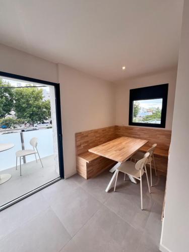 a dining room with a table and chairs and a window at Camping Joncar Mar in Roses