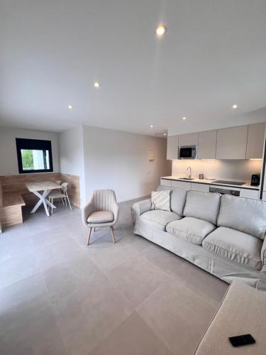 a living room with a couch and a kitchen at Camping Joncar Mar in Roses