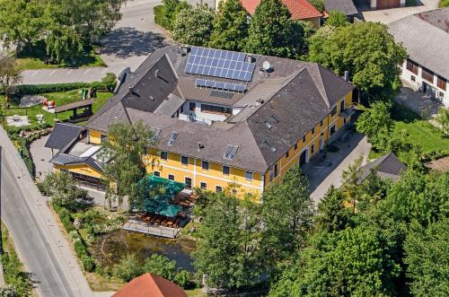 an overhead view of a large yellow house with a solar roof at Perbersdorfer Heuriger in Neuhofen an der Ybbs