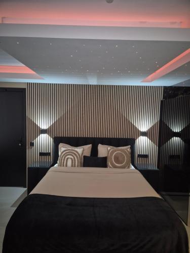 a bedroom with a large bed with lights on it at Hotel Broer & Zus in The Hague