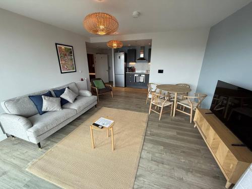a living room with a couch and a table at Wembley Stadium Modern 1 Bed Apartment With Amazing Views in London